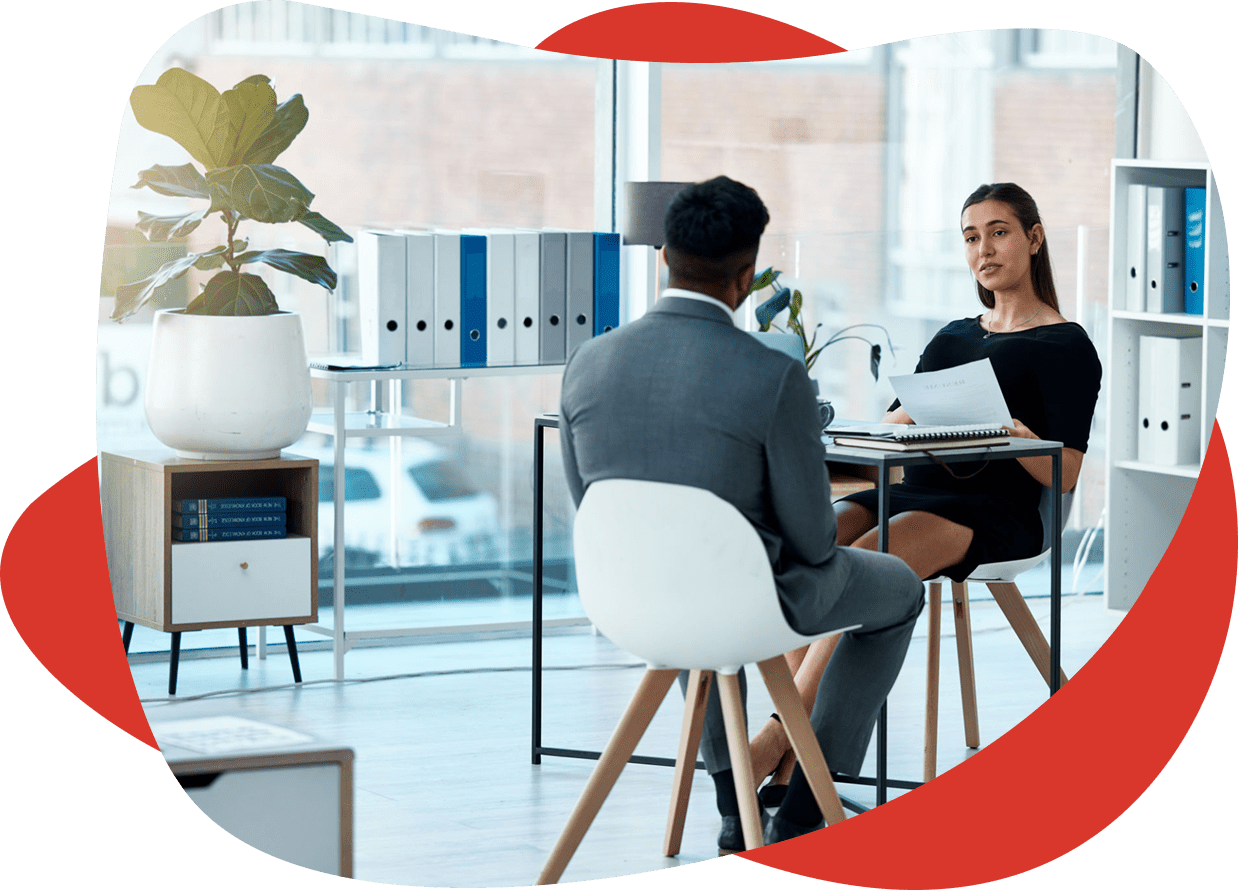 Office meeting with two people discussing documents.