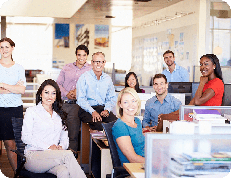 Office team posing in open workspace.